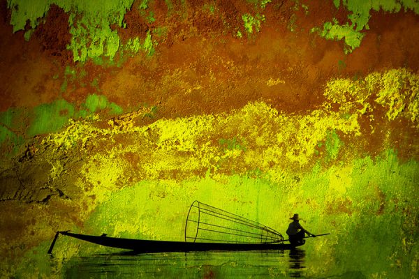 Fisherman on canoe.