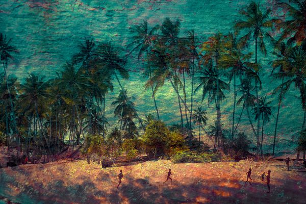 Children running on a beach with coconut palms